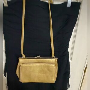 Vintage gold bag with long strap.
